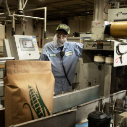 Packaging operator at LifeLine Foods efficiently managing production and ensuring quality control.